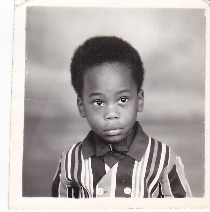 Rowan as a young boy in a striped shirt